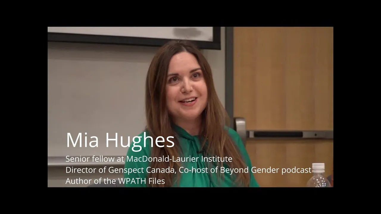 Mia Hughes speaking at a lectern