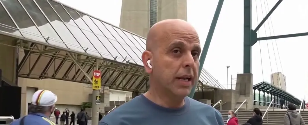 Mike Bayer on a Toronto street with a microphone in front of him